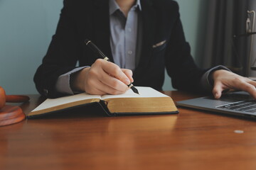 Business and lawyers discussing contract papers with brass scale on desk in office. Law, legal services, advice, justice and law concept picture with film grain effect