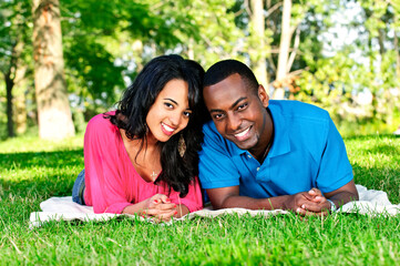 Young romantic couple enjoying summer day in park
