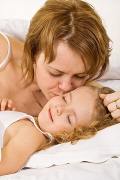 Waking up to a happy day - woman and little girl in the morning