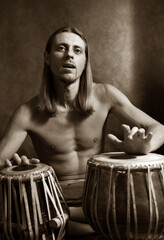 Man playing the nigerian drum in studio