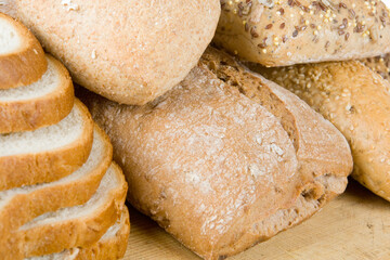 Five types of bread on a wooden cutting board