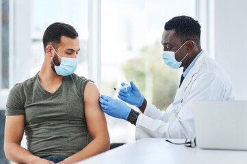 Covid, vaccine and man doctor with syringe in healthcare consultation for safety or prevention. Corona, vaccination and arm injection for guy person by physician in face mask for hospital compliance