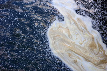 sewage in the form of foam on the water surface, chemical foam on the river