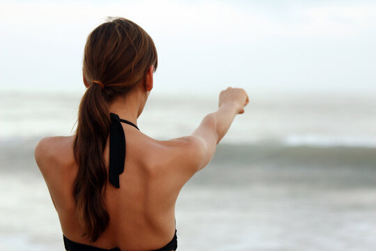punching workout on the beach by sunset