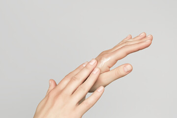 a woman applies a cosmetic cream on her hands. hand skin care concept