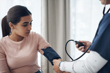 Obraz premium Blood pressure, woman and health test with support at a clinic and healthcare hospital with doctor. Monitor, checking and nurse with young female patient at a wellness and medical consultation
