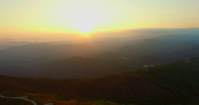 aerial view on the peak in sunset the village far from civilization Traveling on a difficult road..Beautiful sunset view on the hilltop complex..The sun shone through mountain peak after mountain..