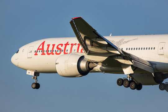 Vienna, Austria - 30 April, 2023: Long haul aircraft Boeing 777 of Austrian Airlines landing in front of blue sky