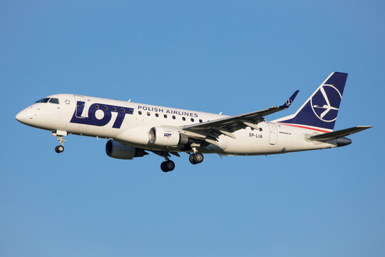 Vienna, Austria - 30 April, 2023: LOT Polish Airlines landing with Embraer 170 airplane in Vienna with clear blue sky