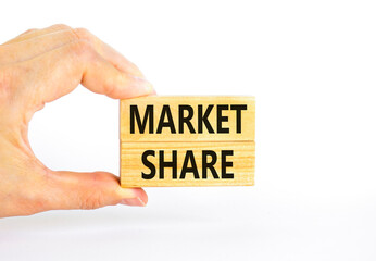 Market share symbol. Concept words Market share on beautiful wooden block. Beautiful white table white background. Businessman hand. Business and Market share concept. Copy space.