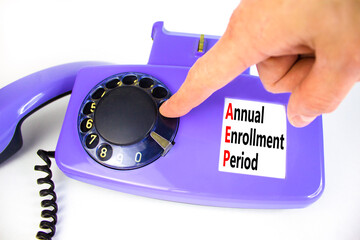 AEP symbol. Concept words AEP Annual enrollment period on beautiful old disk phone. Doctor hand....