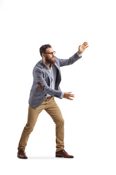 Full length shot of a cheerful bearded man trying to catch something