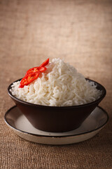 rice bowl with fresh chillies on brown rustic background, Low Key Lighting Technique, Shallow DOF