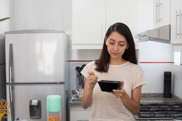 Young woman, eating breakfast in the kitchen