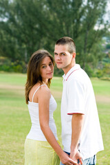 Fototapeta premium beautiful young couple holding hands outdoors