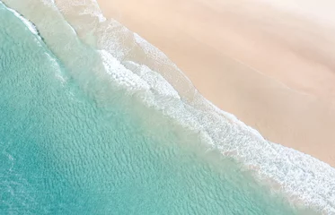 Fototapeten Aerial view of a beach with nice waves and shades of blues. Beautiful beach and scenes © FRPhotos
