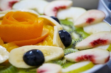 Perfectly designed fresh juicy fruit salad on plate.  Close-up series. Shallow DOF.