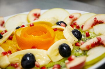 Perfectly designed fresh juicy fruit salad on plate.  Close-up series. Shallow DOF.