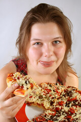 Beautiful no make-up girl eating a piece of Pizza