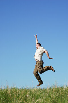 happy man jumping on sky background