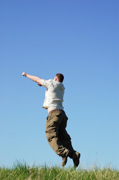 happy man jumping on sky background