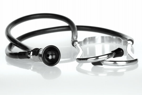 Retro stethoscope on white reflective translucent background