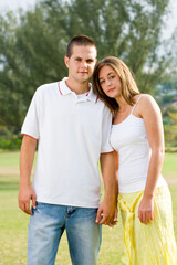 beautiful young couple holding hands outdoors