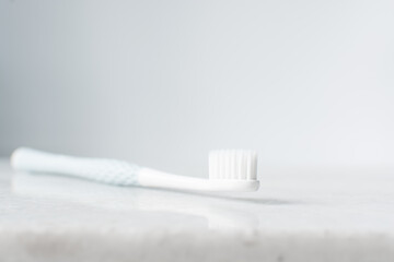 Pastel blue toothbrush with white bristles on a white background, Pastel blue toothbrush with copy...