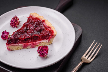 Delicious fragrant sweet pie with cherry berries on a ceramic plate