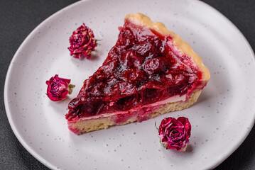Delicious fragrant sweet pie with cherry berries on a ceramic plate