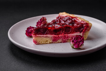 Delicious fragrant sweet pie with cherry berries on a ceramic plate