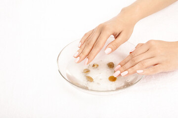 Hands take the salt bath, isolated on a white background