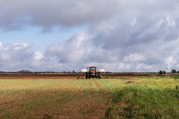 Tractor with 2 chemical tanks ready to work a field, Texas, USA