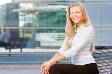 Beautiful attractive blonde business woman looking at you being sweet