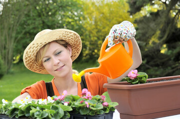 Young woman watering flowers