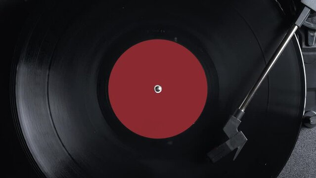 Close up of a vintage retro vinyl record rotating. Old fashioned music. Needle gramophone. 4K ProRes