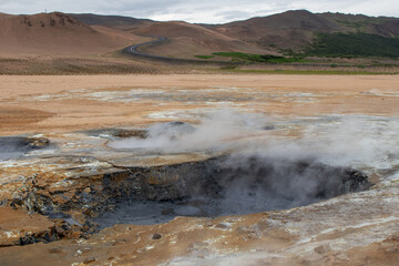 Geothermal mud springs in Iceland with boiling mud pots in a geothermal area
