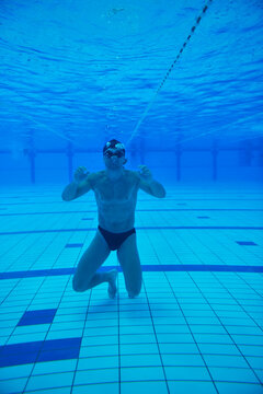 undervater shoot of swimming pool with good looking young swimmer