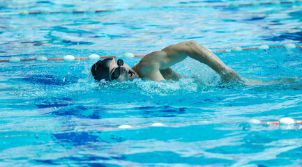young healthy with muscular body man swim on swimming pool and representing healthy and recreation...