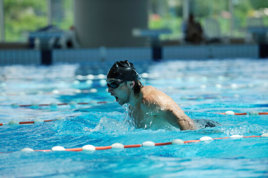 young healthy with muscular body man swim on swimming pool and representing healthy and recreation concept