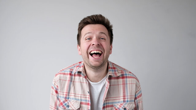 European funny young man is laughing loudly. Positive emotion