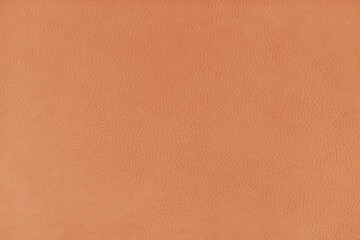 Texture background of orange velours fabric textured like leather surface. Fabric texture close up of upholstery furniture textile material, design interior, wall decor, backdrop, wallpaper.
