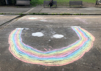 Upside down rainbow drawn on the street with chalk