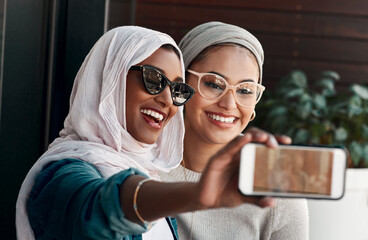 Selfie, muslim people and friends with sunglasses in city for social media, influencer content creation or fashion blog. Happy gen z women in Saudi Arabia, emoji profile picture or online photography - obrazy, fototapety, plakaty