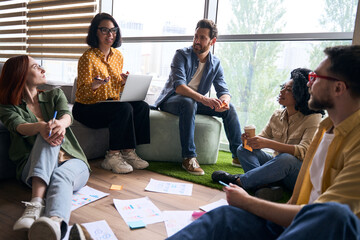Group of smiling multiracial business people, colleagues talking, planning startup, sharing ideas,...
