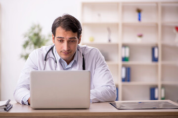 Young male doctor in telemedicine concept