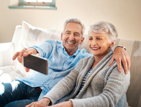 Senior couple, selfie and happy on couch in retirement for social media, blog or post on internet. Elderly man, woman and photography for profile picture on app, web or smile together on lounge sofa