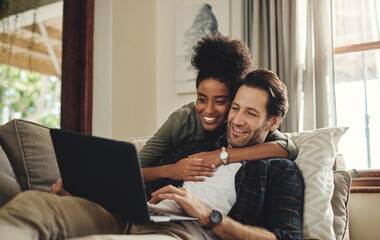 Laptop, streaming and an interracial couple watching a movie using an online subscription service...