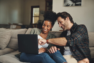 Laptop, interracial and entertainment with a couple watching a video using an online subscription service to relax. Computer, streaming or internet with a man and woman bonding together over a movie