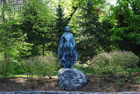 Pilgrim Maiden statue next to her pond in Brewster Gardens. Plymouth, MA.